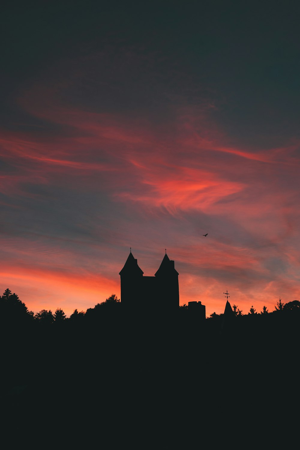 a sunset with a church steeple in the background