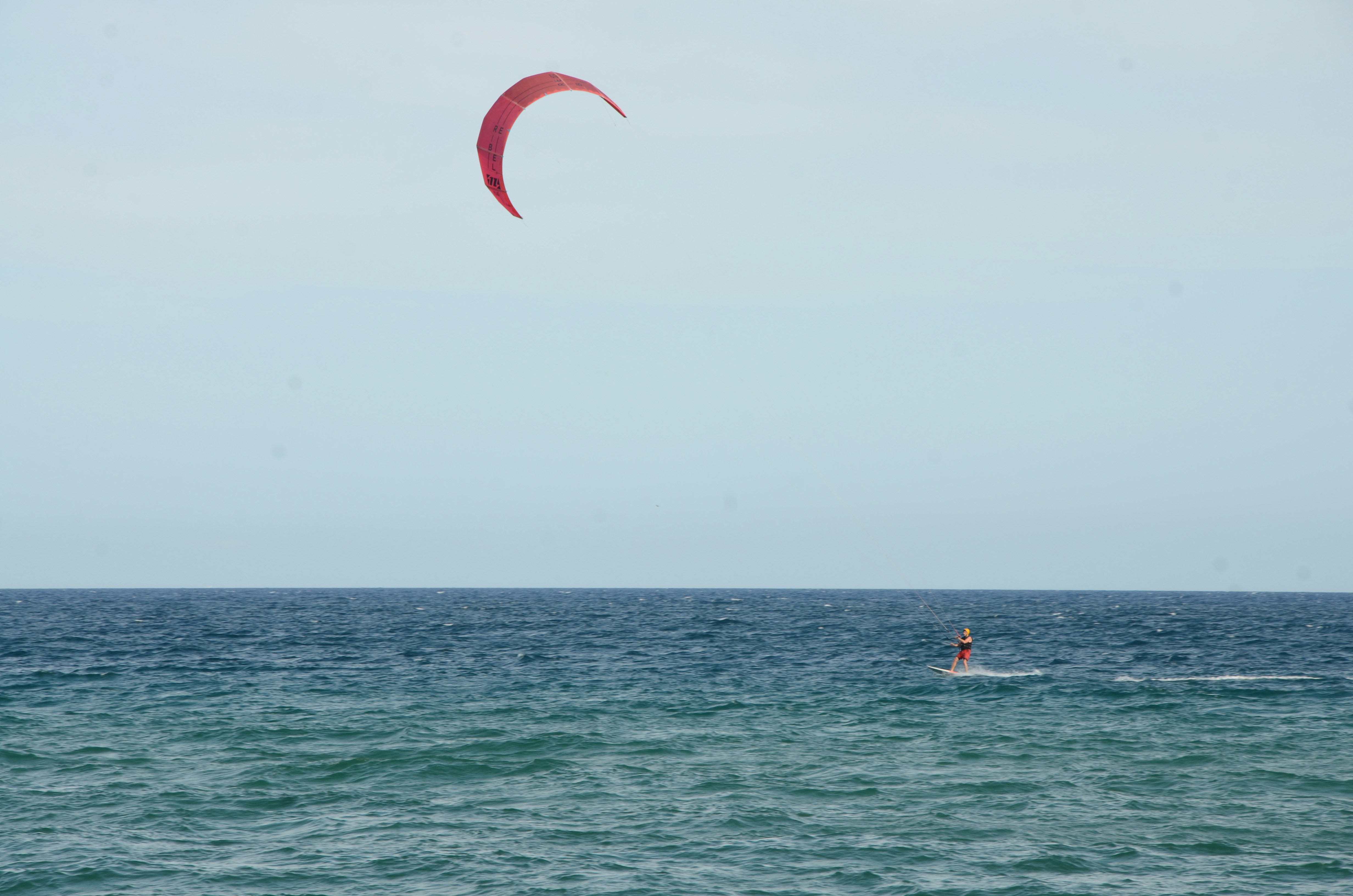 a person para sailing in the ocean on a sunny day