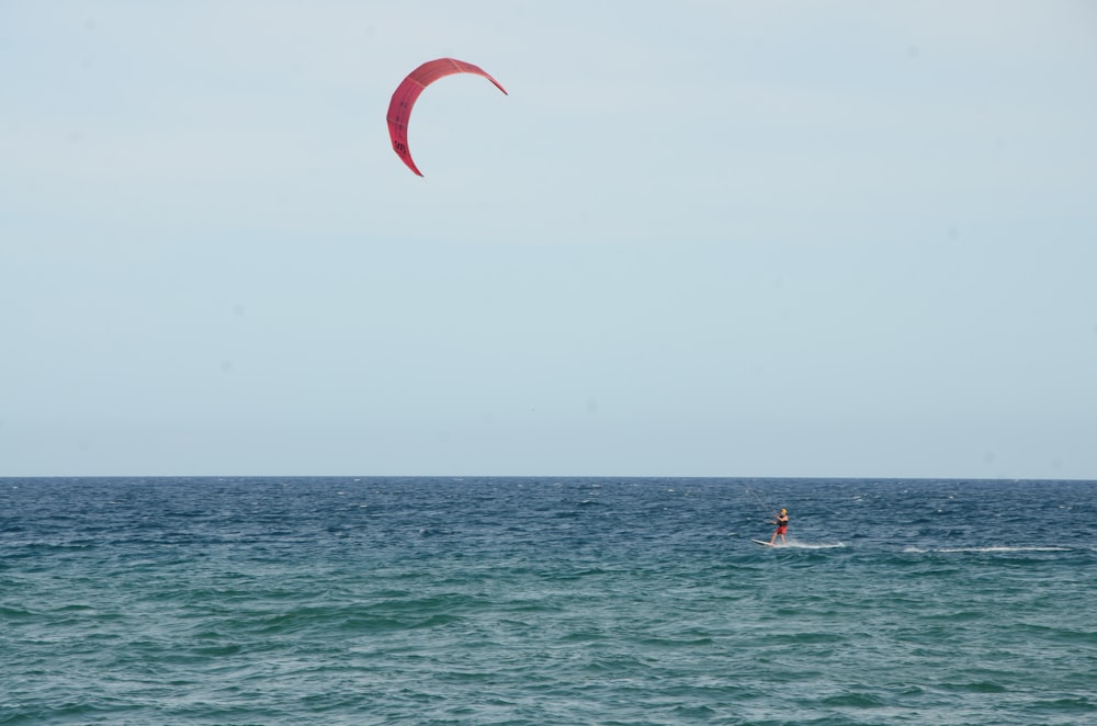 a person para sailing in the ocean on a sunny day