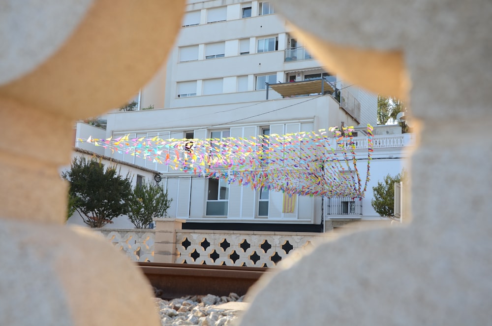 a view of a building through a hole in a wall