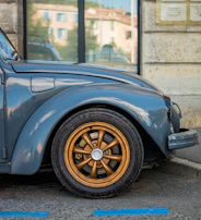 a blue car parked in front of a building