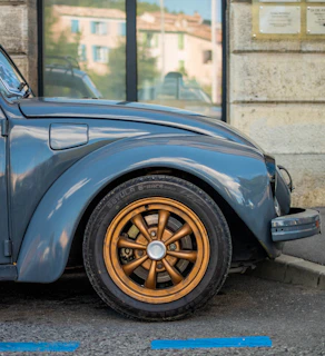 a blue car parked in front of a building