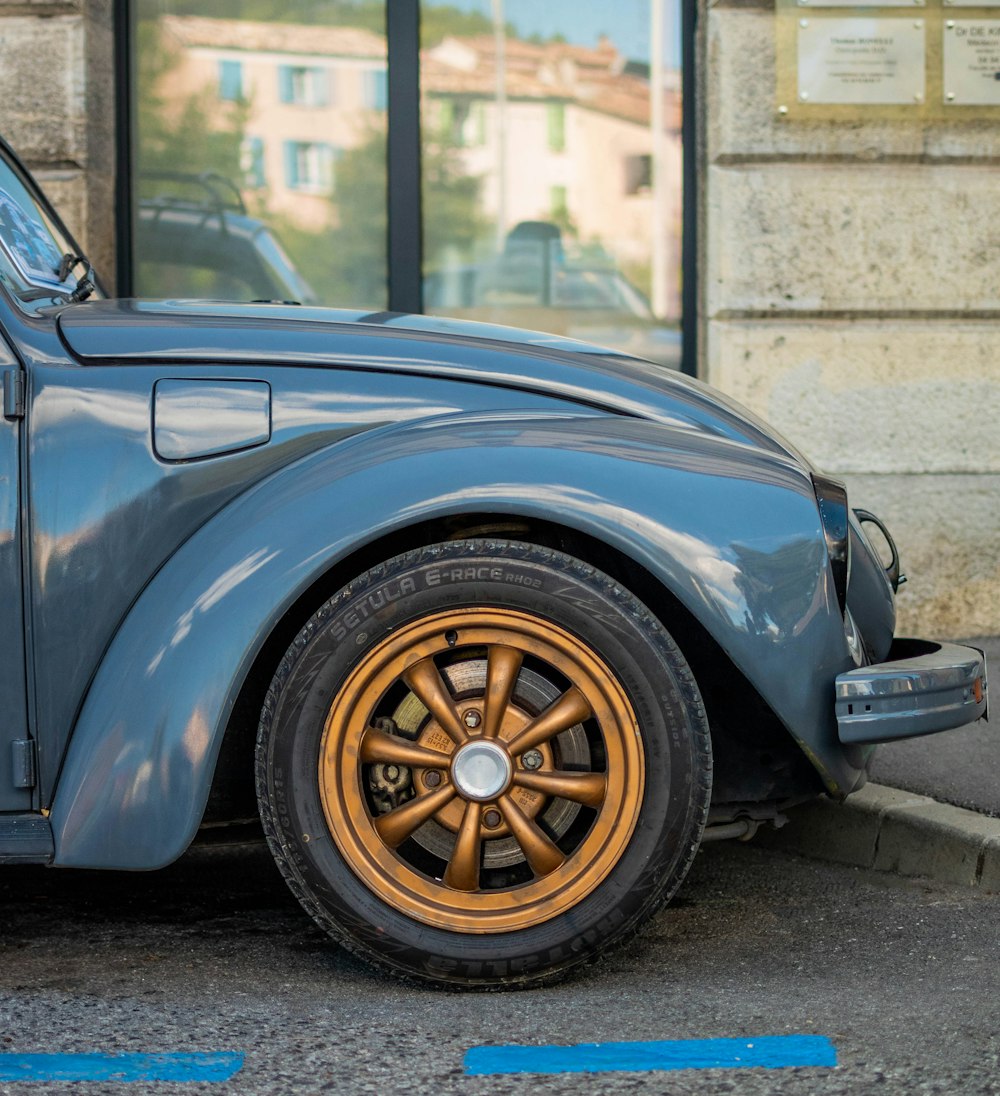 a blue car parked in front of a building