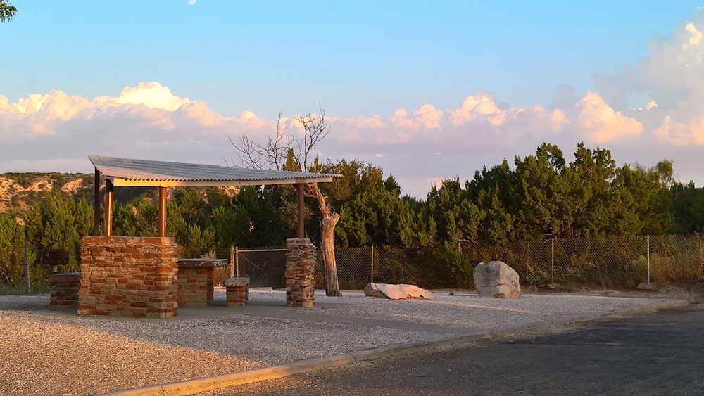 a stone structure in the middle of a gravel road