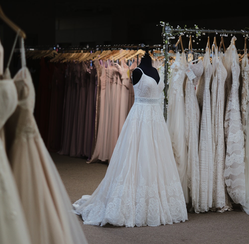 a rack of wedding dresses in a bridal shop