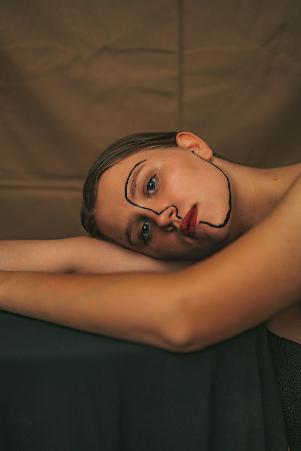 a woman with a face painted on her head