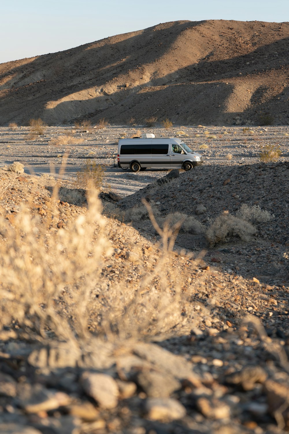 a van driving down a road in the desert