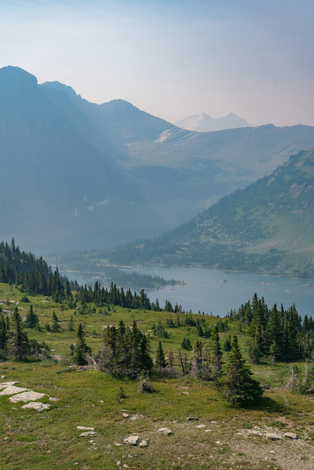 a view of a mountain range with a lake in the distance