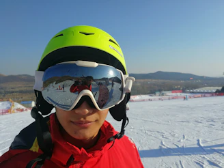 Ergonomic helmet with impact-resistant ABS shell resting on snowy terrain.