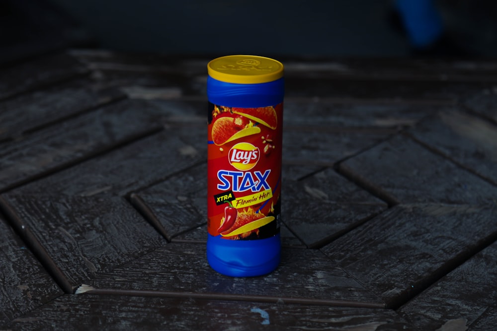 a can of stax on a wooden surface