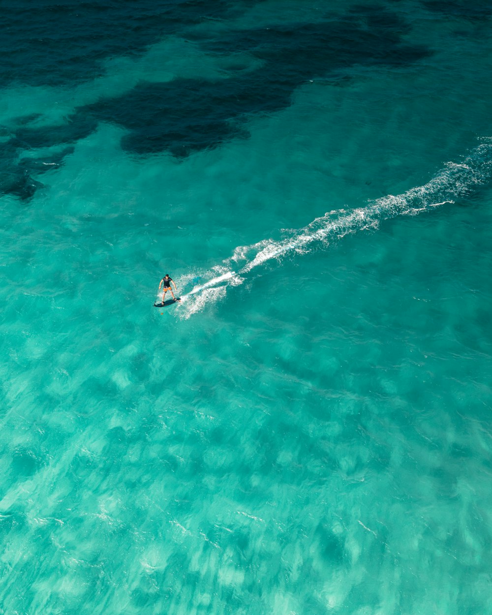 a person riding a surfboard on a body of water