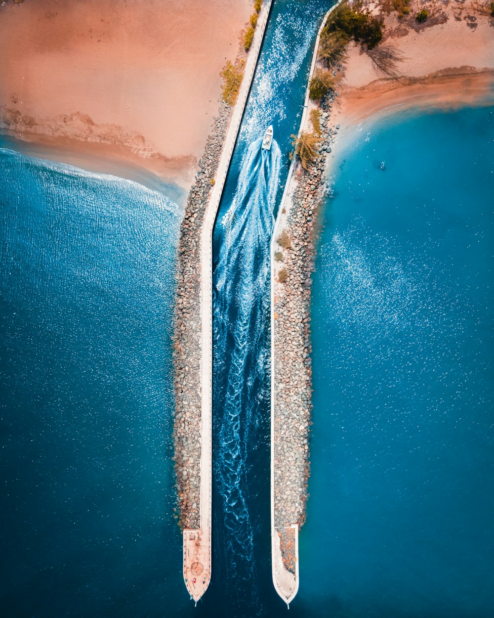 an aerial view of two boats in a body of water