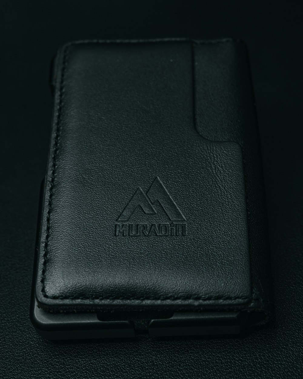 a black wallet sitting on top of a table