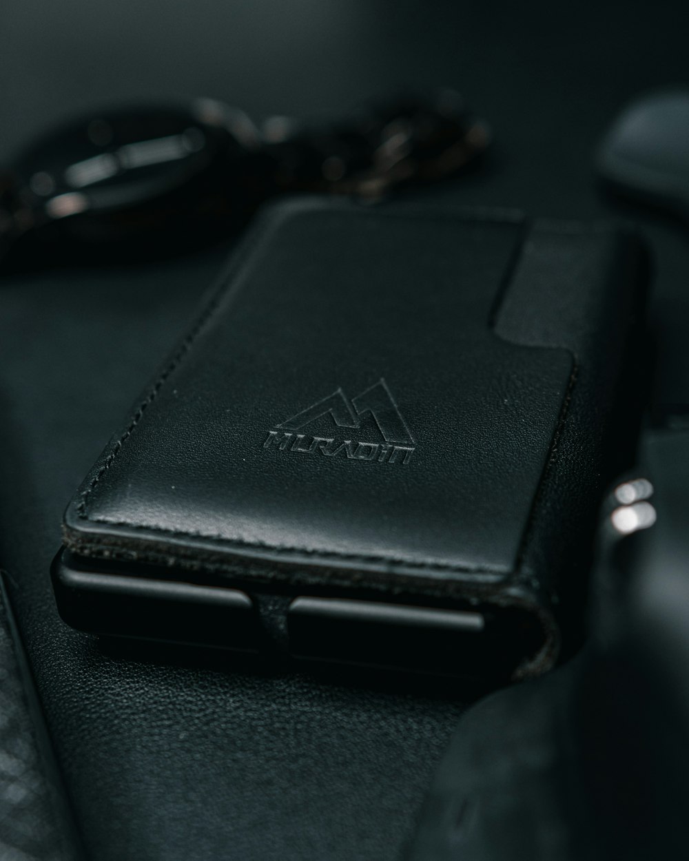 a black leather wallet sitting on top of a table