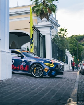 a blue sports car parked on the side of the road