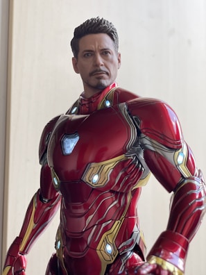 Close-up of a detailed superhero action figure posed dynamically on a sleek shelf.