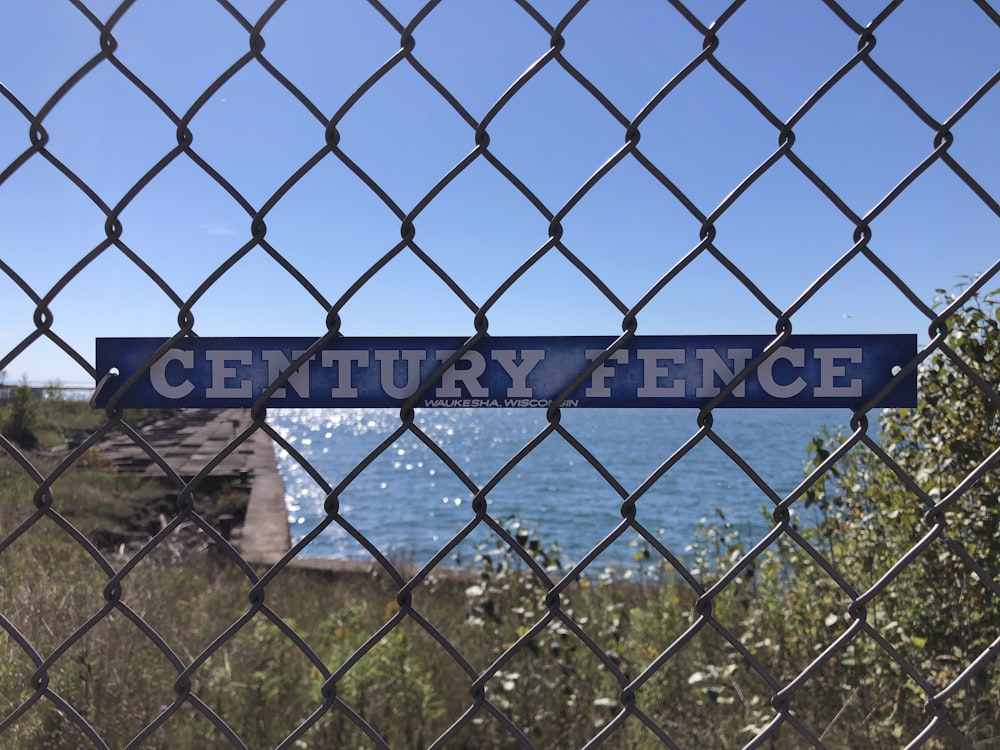 a sign that is on a chain link fence
