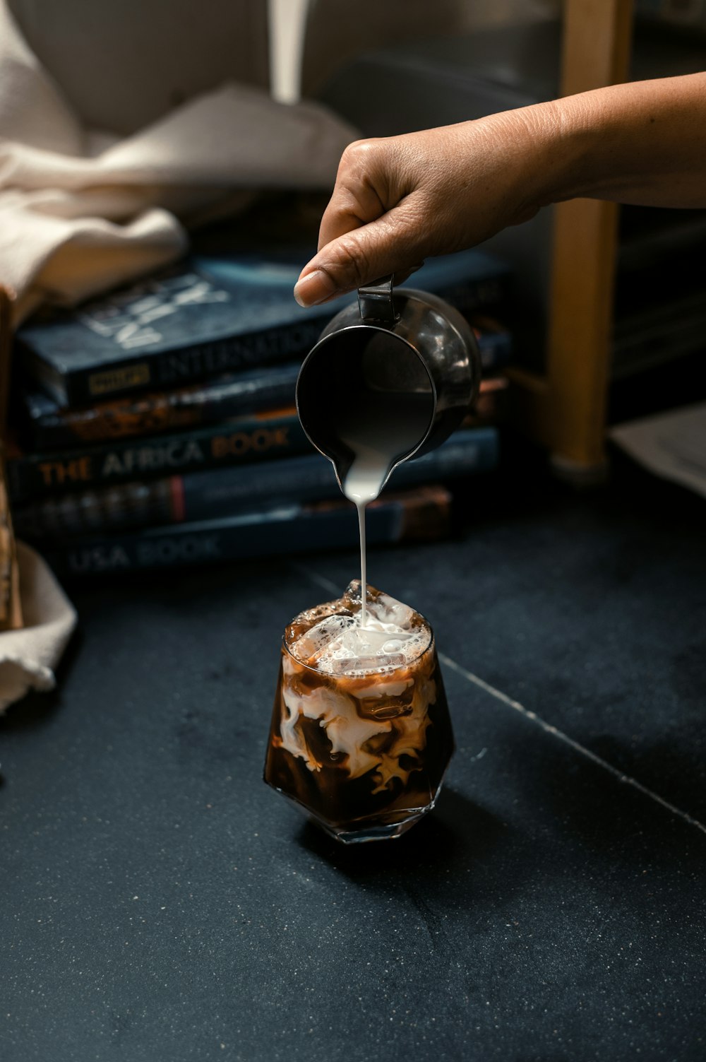 a person pours something into a glass