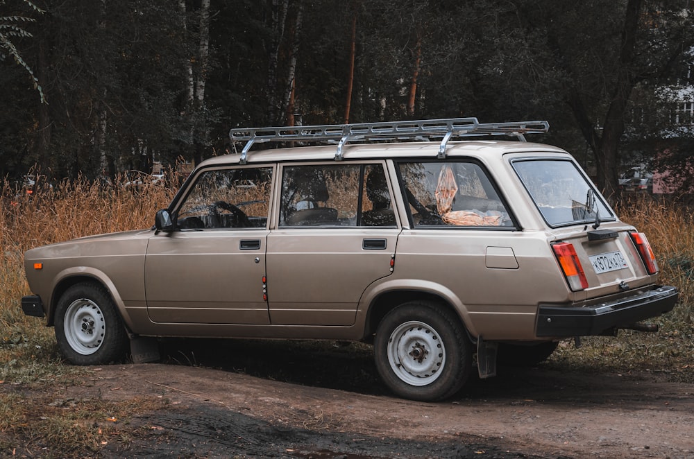 a car parked on a dirt road in a wooded area