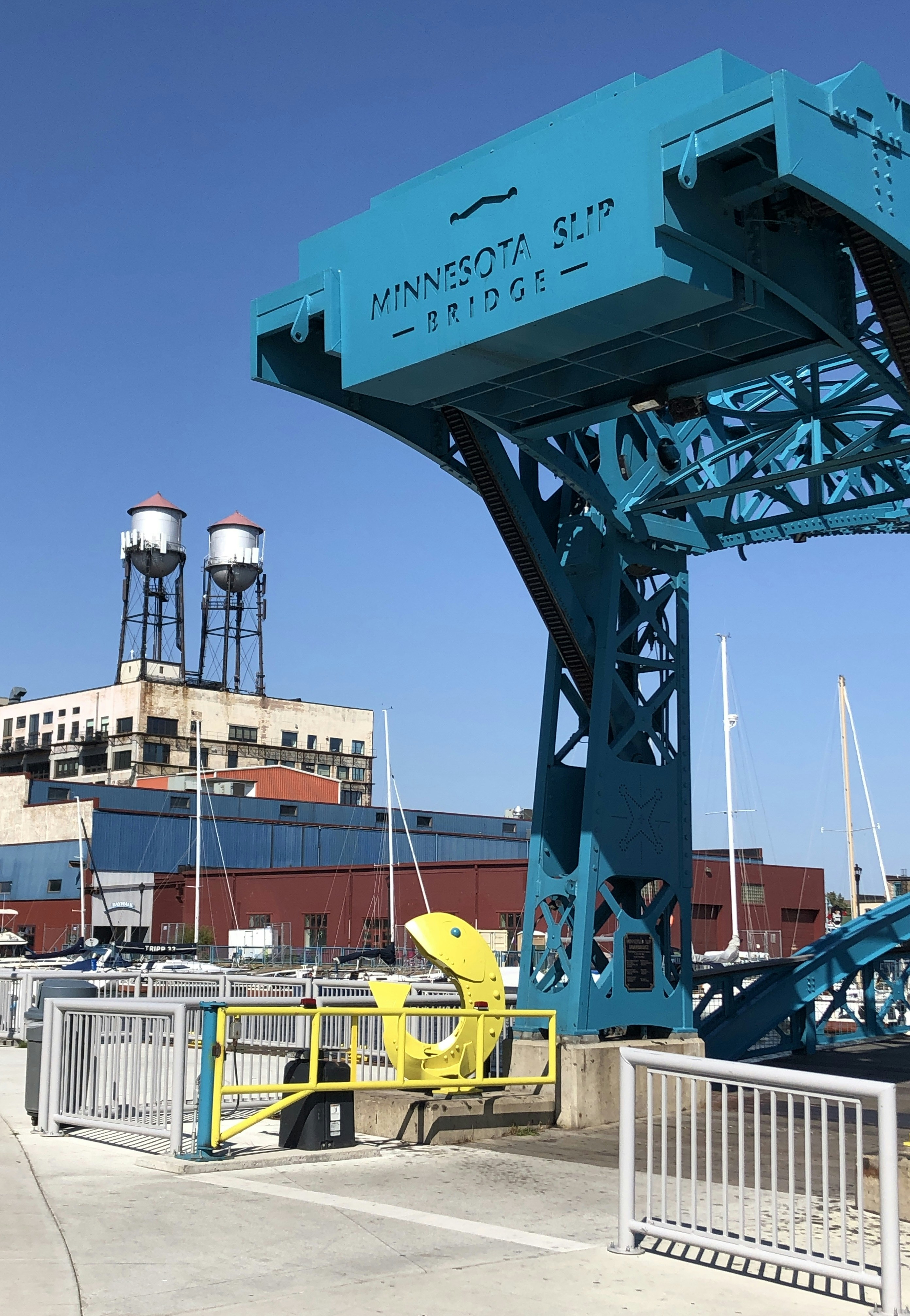 a large blue crane sitting on top of a pier