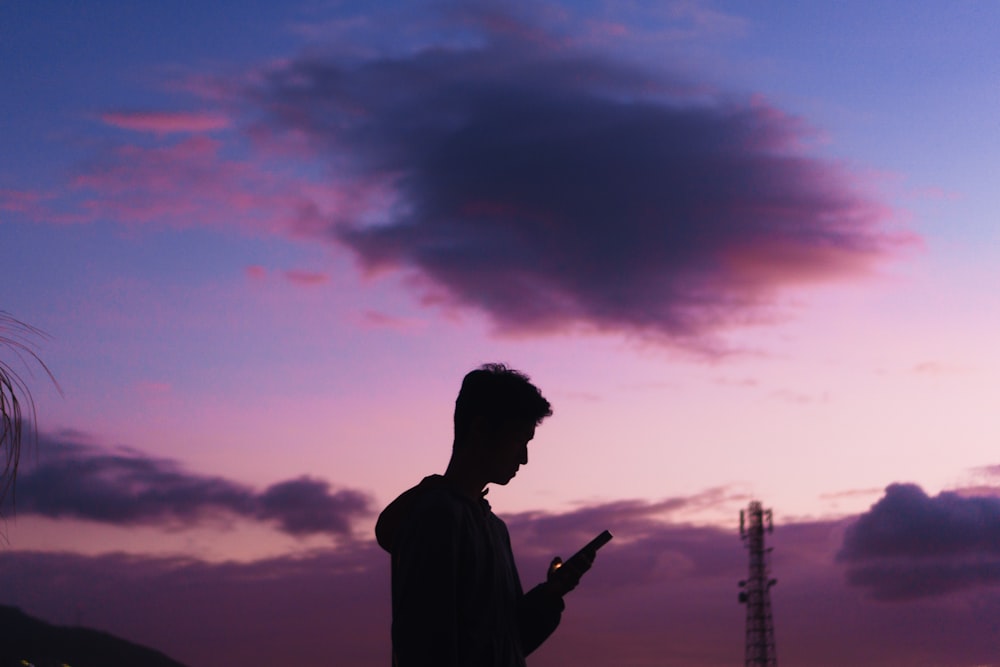 a man is looking at his cell phone