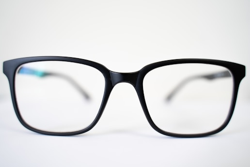 a pair of glasses sitting on top of a table