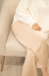 a woman sitting in a chair with her legs crossed