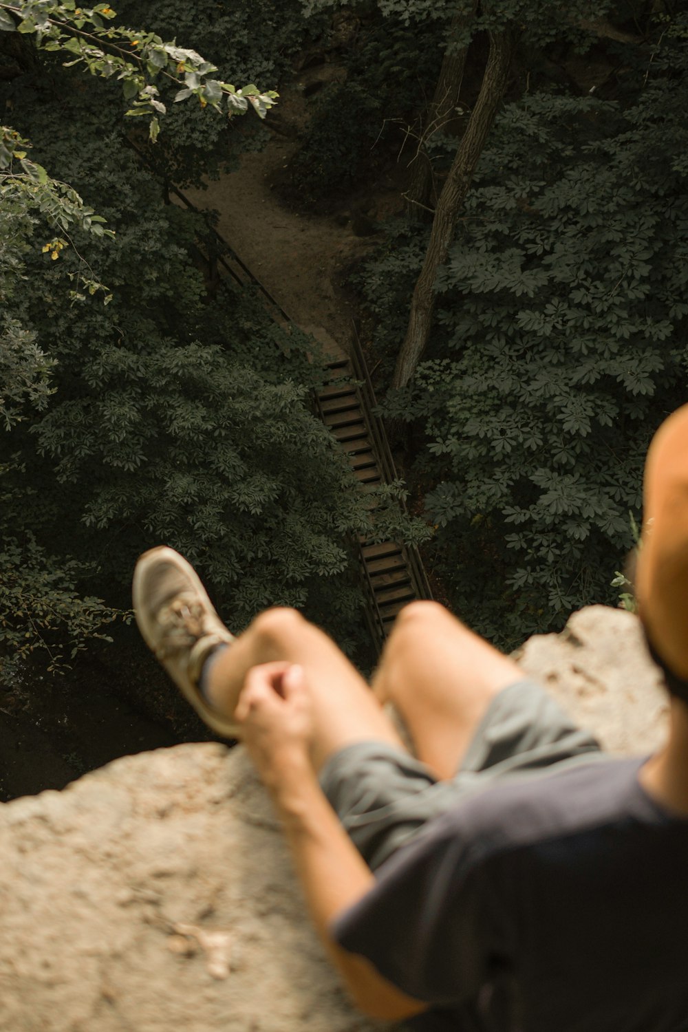 a man sitting on a rock with his feet up