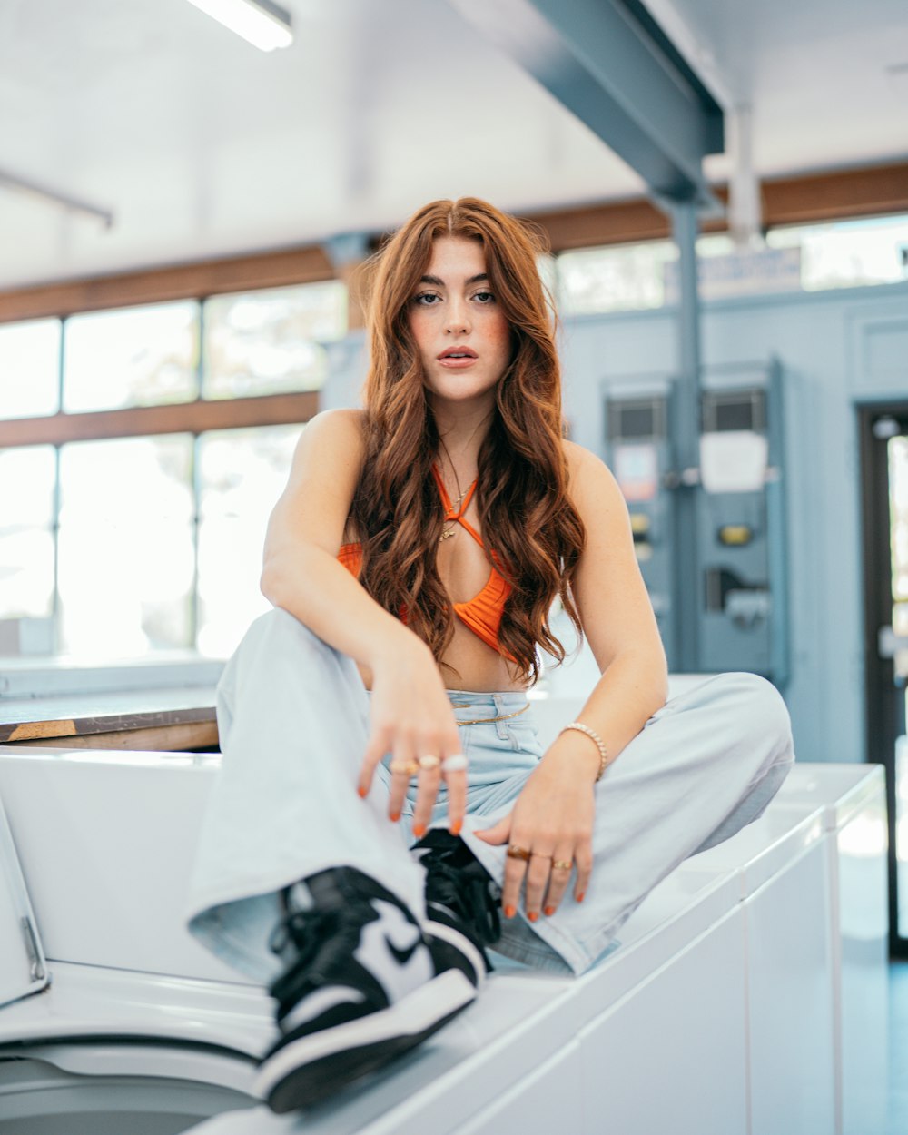 a woman sitting on top of a washing machine