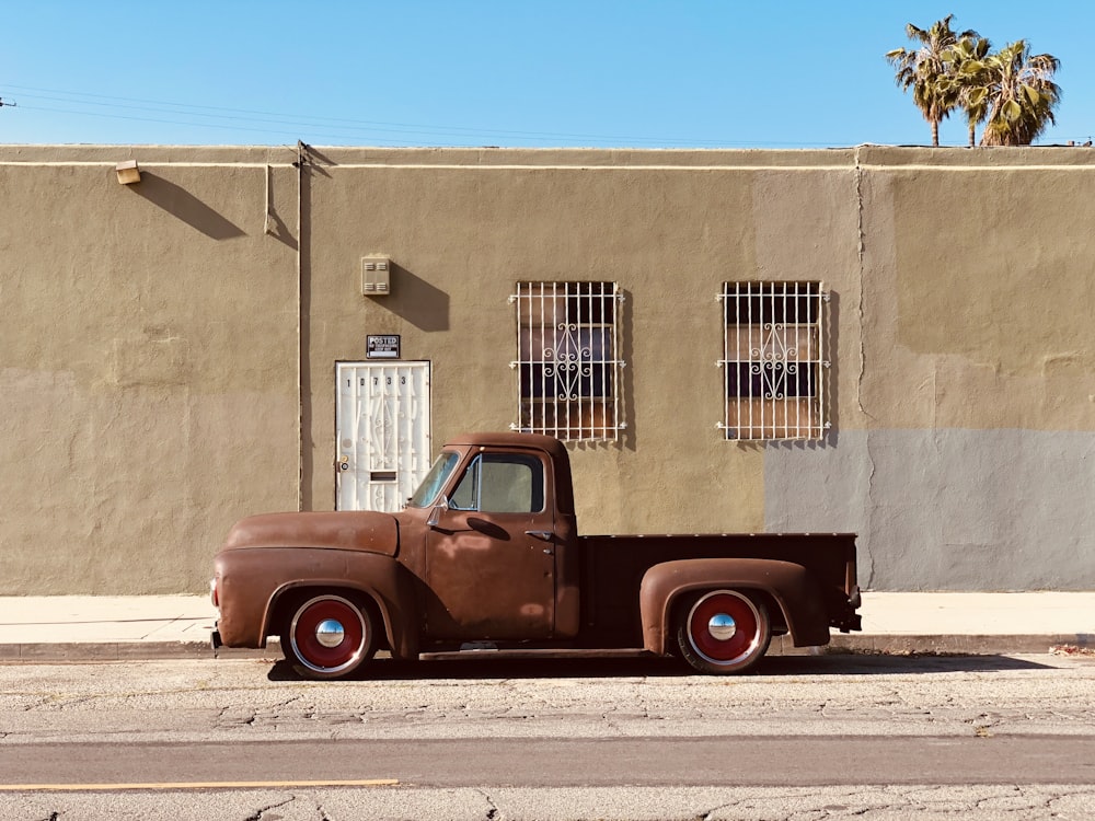 an old truck parked in front of a building