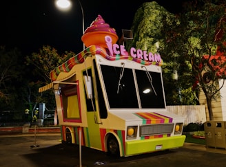 a brightly colored ice cream truck parked in a parking lot