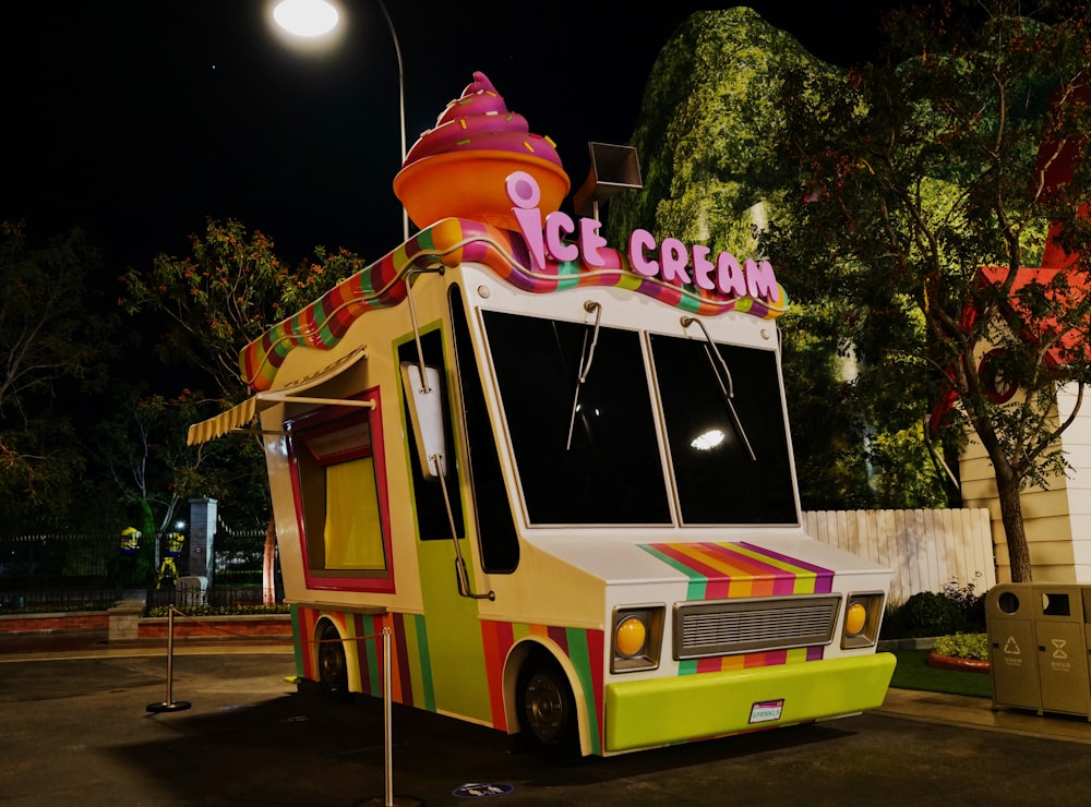 a brightly colored ice cream truck parked in a parking lot