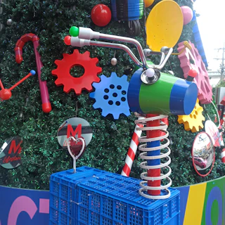 Close-up of a colorful painting featuring intertwined gears and brushstrokes symbolizing art and business synergy.