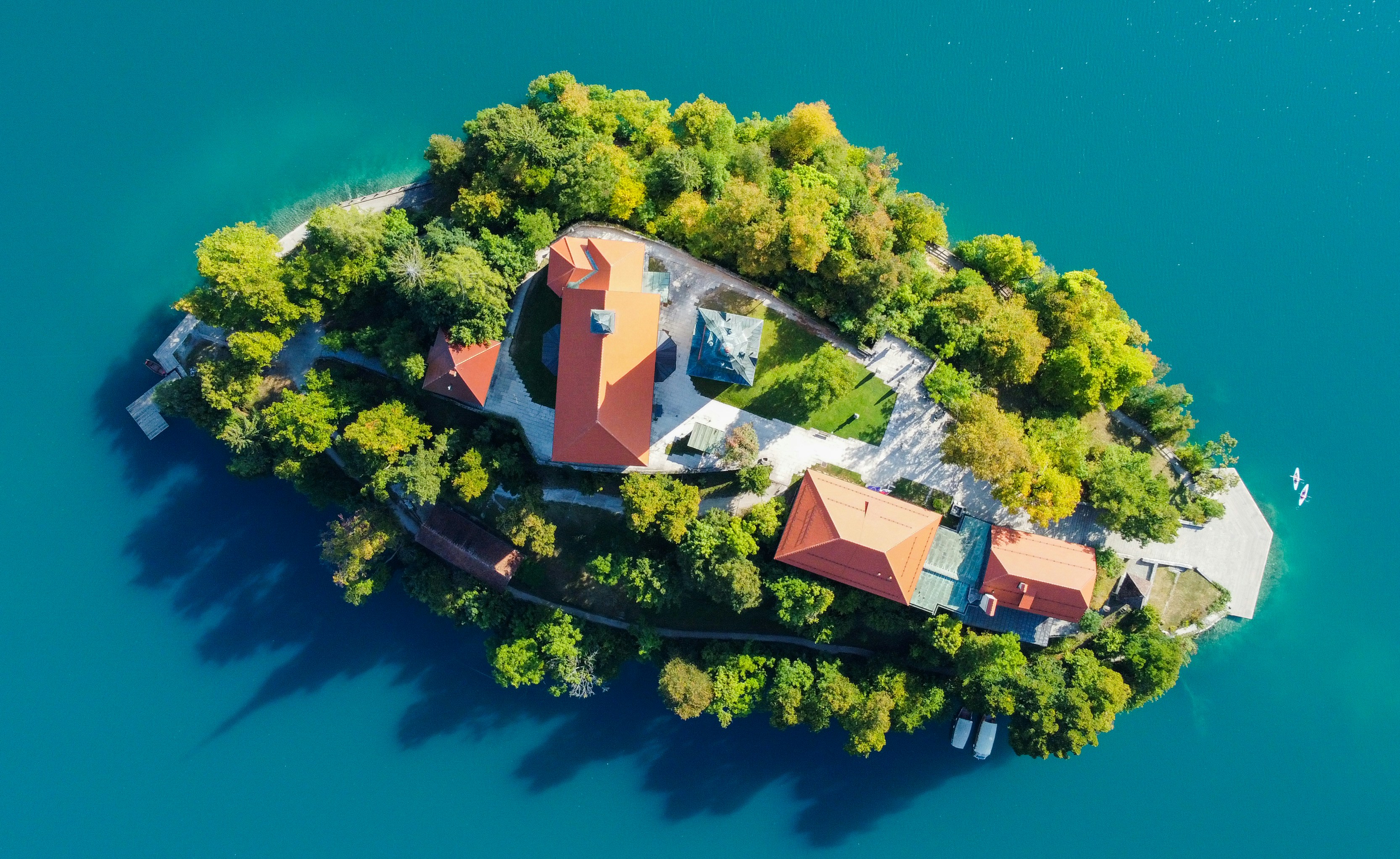 an aerial view of a house on a small island, Lake Bled Slovenia