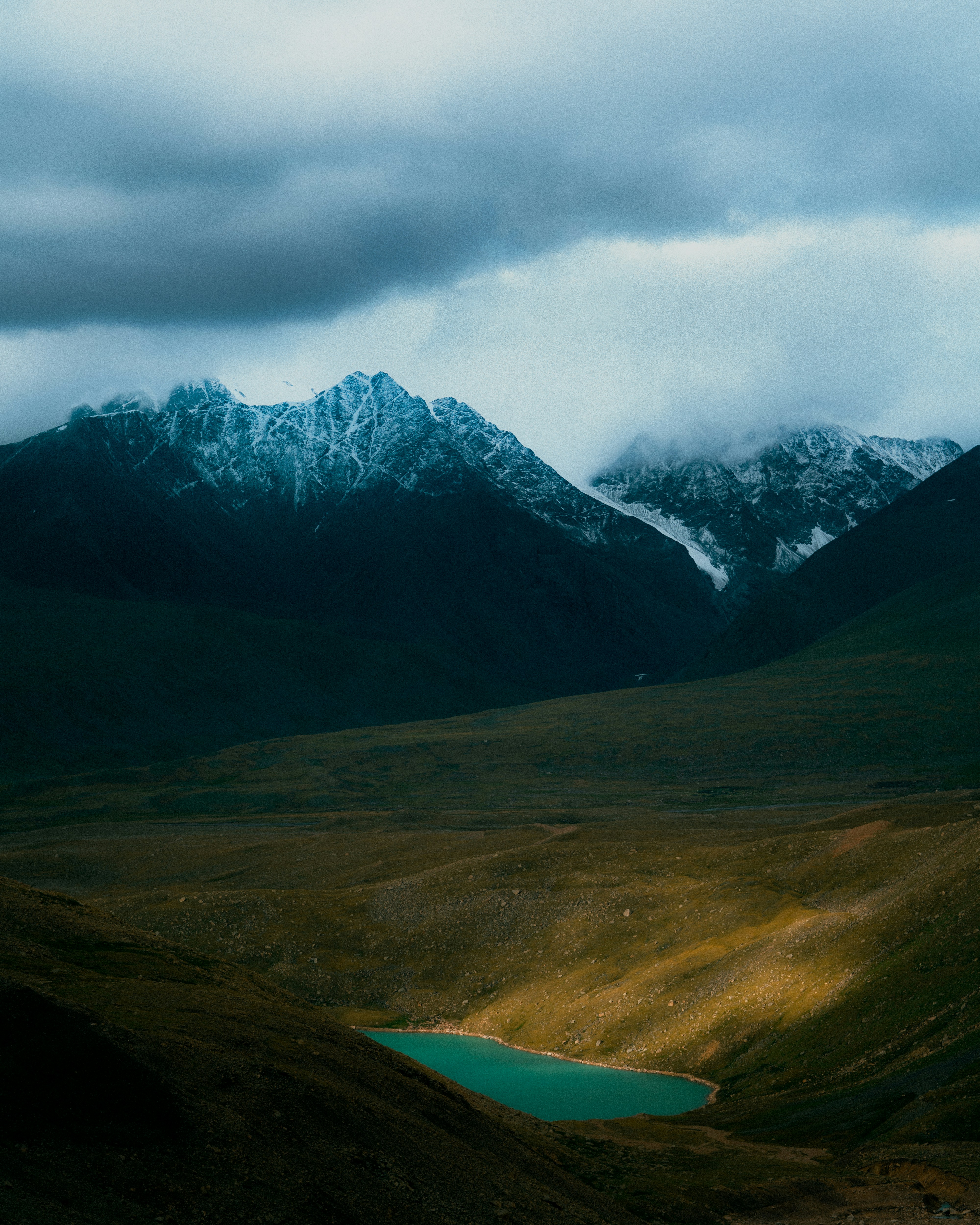 a view of a mountain range with a lake in the foreground