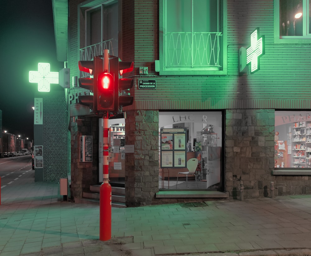 a red traffic light sitting on the side of a road