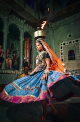 a woman in a colorful dress is performing a dance