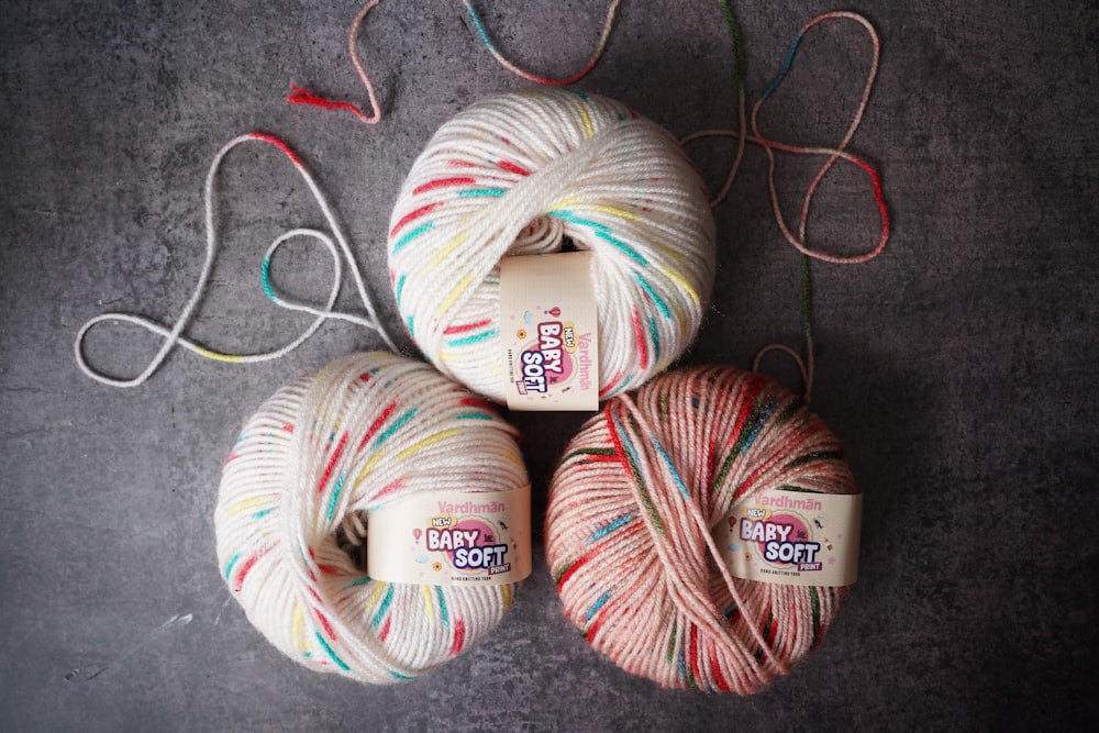 three balls of yarn sitting next to each other