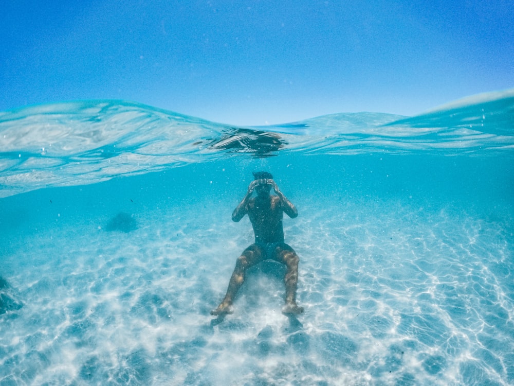 a person in a wet suit swimming in the ocean