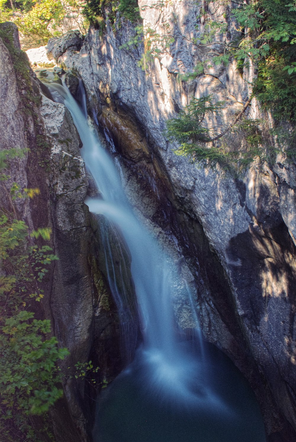 a large waterfall in the middle of a forest