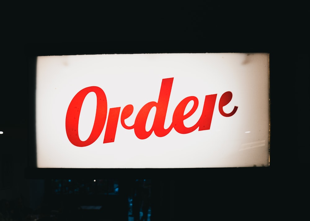 a red order sign hanging from the side of a building