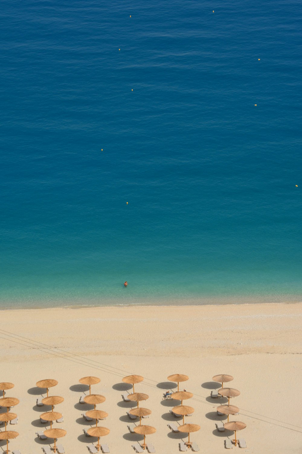 a bunch of umbrellas that are on a beach