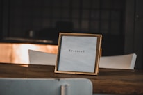 Handcrafted wooden signs displayed on a table.
