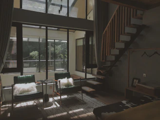 A bright, airy living room in a troff homestay featuring clean lines, natural light, and tasteful minimalist decor.