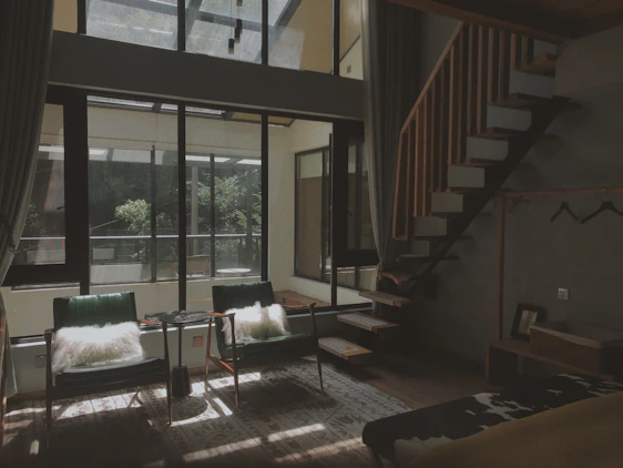 A bright, airy living room in a troff homestay featuring clean lines, natural light, and tasteful minimalist decor.