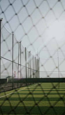 a view of a baseball field through a fence