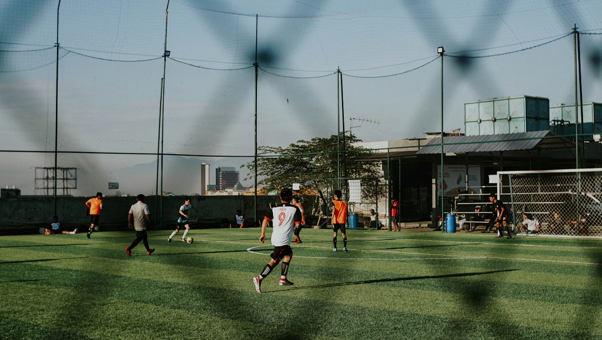 Young players running for the ball in a football game