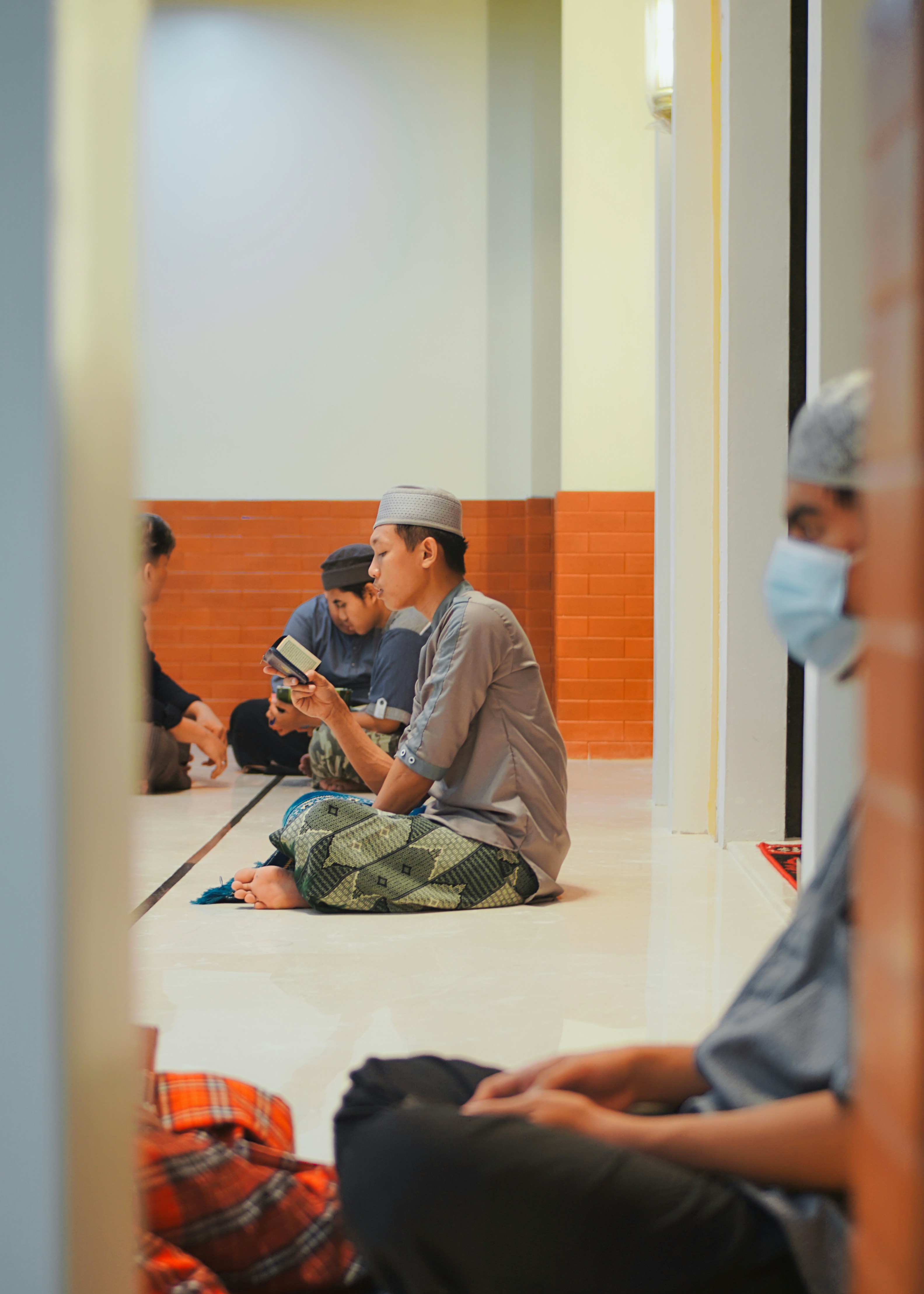 a group of people sitting on the floor in a room