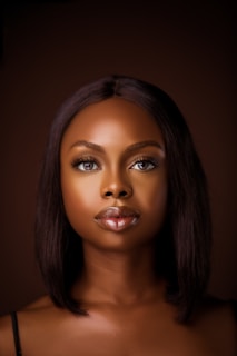 a woman's face is shown with a dark background