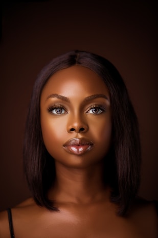 a woman's face is shown with a dark background